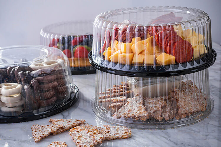 clear dome container platters with cheese, meats and desserts