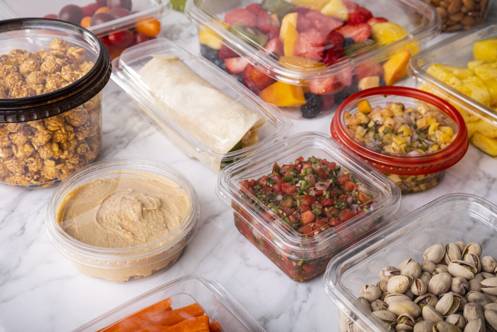 Clear containers rounded, squared and rectangle with a variety of salsa dips and snacks