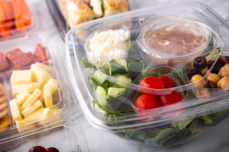 Salad bowl container with compartments for dressing and toppings