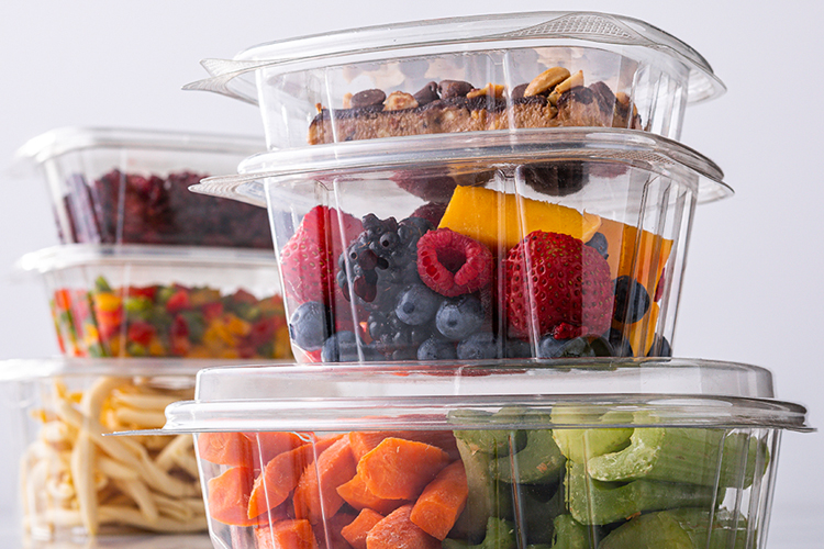 Stacked square clear containers with assorted fruit and vegetables
